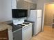 Well-equipped kitchen with modern appliances including a white refrigerator and oven, plus ample cabinet space at 4042 E Carson Rd, Phoenix, AZ 85042