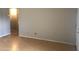 Living room displaying hardwood floors, neutral paint, and an open entryway at 4042 E Carson Rd, Phoenix, AZ 85042