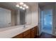 Bathroom featuring a vanity and a mirror with modern lighting fixtures at 41767 W Somerset Dr, Maricopa, AZ 85138