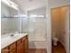 Clean bathroom featuring a single sink vanity, large mirror and glass shower door at 41767 W Somerset Dr, Maricopa, AZ 85138