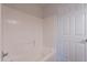 Bathroom with tiled shower and tub combination, alongside a toilet and door at 41767 W Somerset Dr, Maricopa, AZ 85138