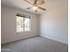 Cozy bedroom featuring a ceiling fan and a window providing natural light at 41767 W Somerset Dr, Maricopa, AZ 85138