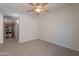 Comfortable bedroom featuring a ceiling fan and easy access to the kitchen at 41767 W Somerset Dr, Maricopa, AZ 85138