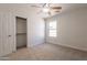 Bright bedroom featuring a ceiling fan, window, carpeted floors and a closet at 41767 W Somerset Dr, Maricopa, AZ 85138