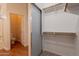 Walk-in closet featuring shelves and storage that connect to the adjoining bathroom at 41767 W Somerset Dr, Maricopa, AZ 85138