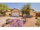 Lovely single-story home featuring a well-manicured lawn and two-car garage at 41767 W Somerset Dr, Maricopa, AZ 85138