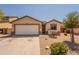 Single-story home with a two-car garage and desert landscaping at 41767 W Somerset Dr, Maricopa, AZ 85138
