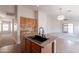 Open-concept kitchen view showcases a center island, stainless appliances, and natural light, perfect for cooking at 41767 W Somerset Dr, Maricopa, AZ 85138