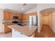 Bright kitchen with stainless steel appliances, featuring abundant cabinet space and a convenient island with a sink at 41767 W Somerset Dr, Maricopa, AZ 85138