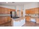 Well-lit kitchen featuring an island sink, lots of counter space, and stainless steel appliances at 41767 W Somerset Dr, Maricopa, AZ 85138