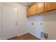 Laundry room featuring tile floor, storage cabinets, and washer/dryer hookups at 41767 W Somerset Dr, Maricopa, AZ 85138