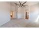 Bright, spacious living room with neutral carpet and doorways to other rooms at 41767 W Somerset Dr, Maricopa, AZ 85138