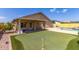 Backyard features a pool, putting green, and covered patio at 4307 E Shetland Dr, San Tan Valley, AZ 85140