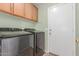 Laundry room with wood cabinets and newer washer and dryer at 4307 E Shetland Dr, San Tan Valley, AZ 85140