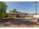Large backyard with a covered patio and mature trees at 4501 W Crittenden Ln, Phoenix, AZ 85031