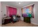 Bedroom with bright decor, tile floors, ceiling fan and pink curtains at 4501 W Crittenden Ln, Phoenix, AZ 85031