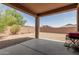 Covered patio looks out to backyard with gravel and block wall and a grill at 5039 S 237Th Ln, Buckeye, AZ 85326