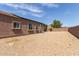 Gravel backyard featuring solar panels and a view of the back of the property showcasing the exterior at 5039 S 237Th Ln, Buckeye, AZ 85326