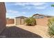 Backyard featuring gravel, block wall, and shed at 5039 S 237Th Ln, Buckeye, AZ 85326