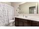 Bathroom with vanity and mirror plus shower-tub combo with polka dot curtain at 5039 S 237Th Ln, Buckeye, AZ 85326