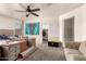 Bedroom with carpet flooring, a ceiling fan, and an open walk-in closet at 5039 S 237Th Ln, Buckeye, AZ 85326
