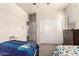 Carpeted bedroom includes a ceiling fan and view to closet doors at 5039 S 237Th Ln, Buckeye, AZ 85326