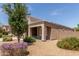 Single-story home with desert landscaping, a covered porch, and a mature shade tree at 5039 S 237Th Ln, Buckeye, AZ 85326