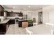 Modern kitchen with stainless steel appliances, dark wood cabinets, granite countertops, and an island at 5039 S 237Th Ln, Buckeye, AZ 85326