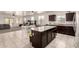 Modern kitchen with granite countertops, stainless appliances, an island, and an open concept layout at 5039 S 237Th Ln, Buckeye, AZ 85326