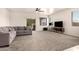 Large living room with a neutral color scheme and carpet, a sliding glass door, and a ceiling fan at 5039 S 237Th Ln, Buckeye, AZ 85326