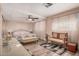 Spacious bedroom with a ceiling fan, large bed, and cozy seating area perfect for relaxation at 506 S 81St Pl, Mesa, AZ 85208