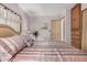 Comfortable bedroom with a plush bed, fan, closet and a cozy atmosphere with natural light at 506 S 81St Pl, Mesa, AZ 85208