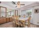 Dining room featuring wood flooring, large window, and sideboard for extra storage at 506 S 81St Pl, Mesa, AZ 85208