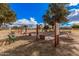 Outdoor horseshoe pits with benches and mature trees on a bright, sunny day at 506 S 81St Pl, Mesa, AZ 85208