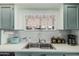 Charming kitchen with blue cabinets, stainless steel sink, and window with pleasant view at 506 S 81St Pl, Mesa, AZ 85208
