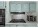 Well-equipped kitchen with range, oven, and ample blue cabinet storage space at 506 S 81St Pl, Mesa, AZ 85208
