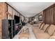 Spacious living room featuring wood-paneled walls, tile flooring, and plenty of room to relax and entertain at 506 S 81St Pl, Mesa, AZ 85208