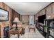 Cozy living room with wood-paneled walls, comfortable seating, and ample entertainment space at 506 S 81St Pl, Mesa, AZ 85208