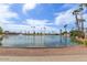Scenic community pond featuring a fountain and palm trees, creating a tranquil setting at 506 S 81St Pl, Mesa, AZ 85208