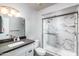 Bright bathroom featuring a marble-walled shower with glass door, white vanity and modern fixtures at 540 Leisure World --, Mesa, AZ 85206