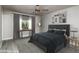 Staged bedroom featuring modern decor, a cozy bed, and a sunlit window at 540 Leisure World --, Mesa, AZ 85206