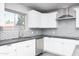 Close up on the kitchen featuring white cabinetry, stainless steel appliances, gray countertops, and subway tile backsplash at 540 Leisure World --, Mesa, AZ 85206