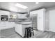 Bright kitchen featuring white cabinets, stainless steel appliances, an island, and sleek gray countertops at 540 Leisure World --, Mesa, AZ 85206