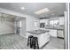 An open kitchen with white cabinets, stainless steel appliances, a center island and modern gray flooring at 540 Leisure World --, Mesa, AZ 85206