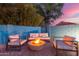 Inviting backyard seating area with a modern fire pit, perfect for relaxing evenings outdoors under the evening sky at 6325 E Helm Dr, Scottsdale, AZ 85254