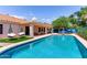 Inviting backyard pool with cabana swings, and blue accents create a refreshing and stylish outdoor living space at 6325 E Helm Dr, Scottsdale, AZ 85254