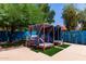 Relaxing outdoor seating area with cushioned canopy daybeds, lush plants and privacy fencing, perfect for lounging and entertaining at 6325 E Helm Dr, Scottsdale, AZ 85254