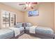This bedroom features two twin beds, neutral decor, and shuttered windows at 6325 E Helm Dr, Scottsdale, AZ 85254