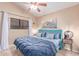 This bedroom features a ceiling fan, window with curtains, and neutral decor at 6325 E Helm Dr, Scottsdale, AZ 85254