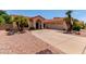 Inviting single-story home featuring a red tile roof and manicured desert landscaping at 6325 E Helm Dr, Scottsdale, AZ 85254